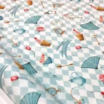 Light-colored fabric with Alice pattern and checkerboard design.