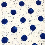 White sofa fabric with blue polka dots.